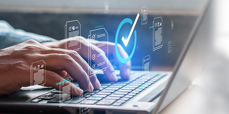 hands typing on a computer with checkmark for process efficiences